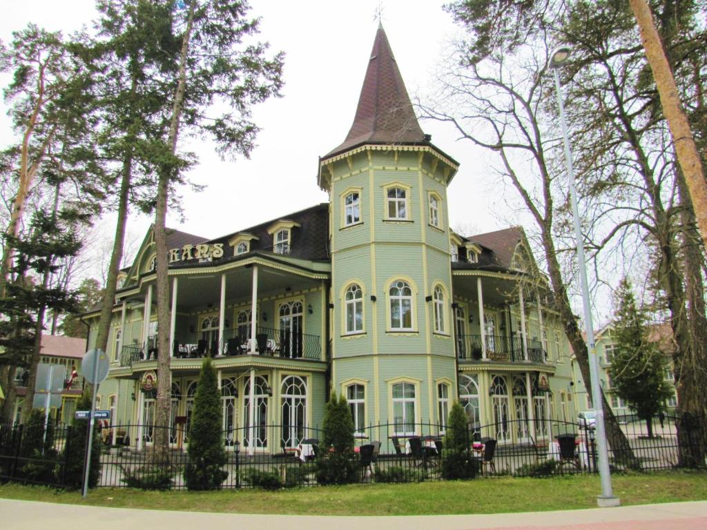 a large house with a turret on top of it at Pegasa Pils Spa Hotel in Jūrmala