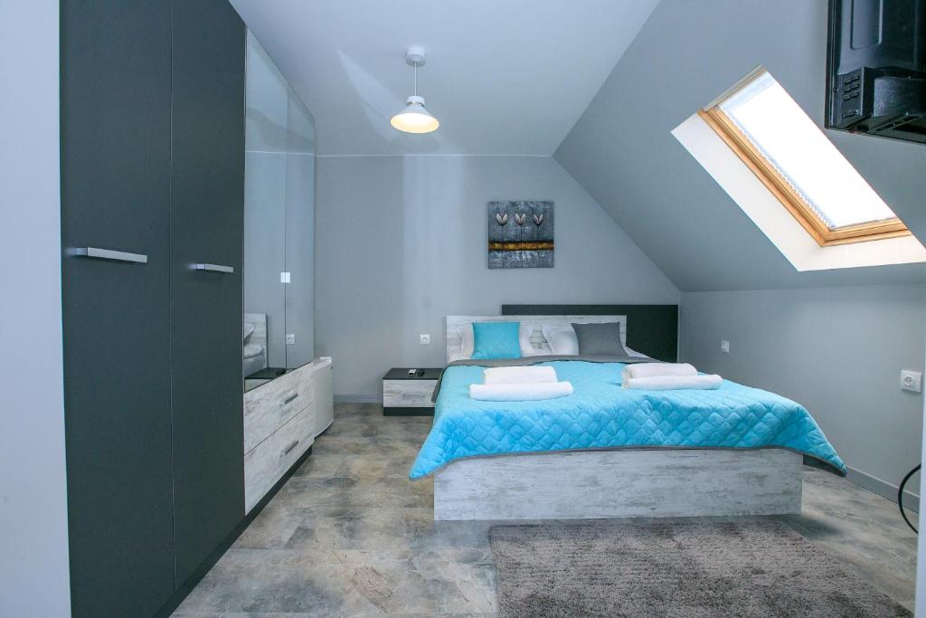 a bedroom with a bed and a skylight at Sunpark Studios in Sandanski