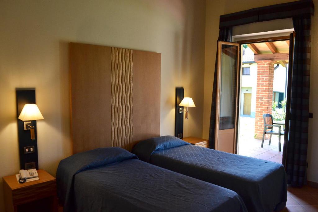 Postel nebo postele na pokoji v ubytování Ariotto Village