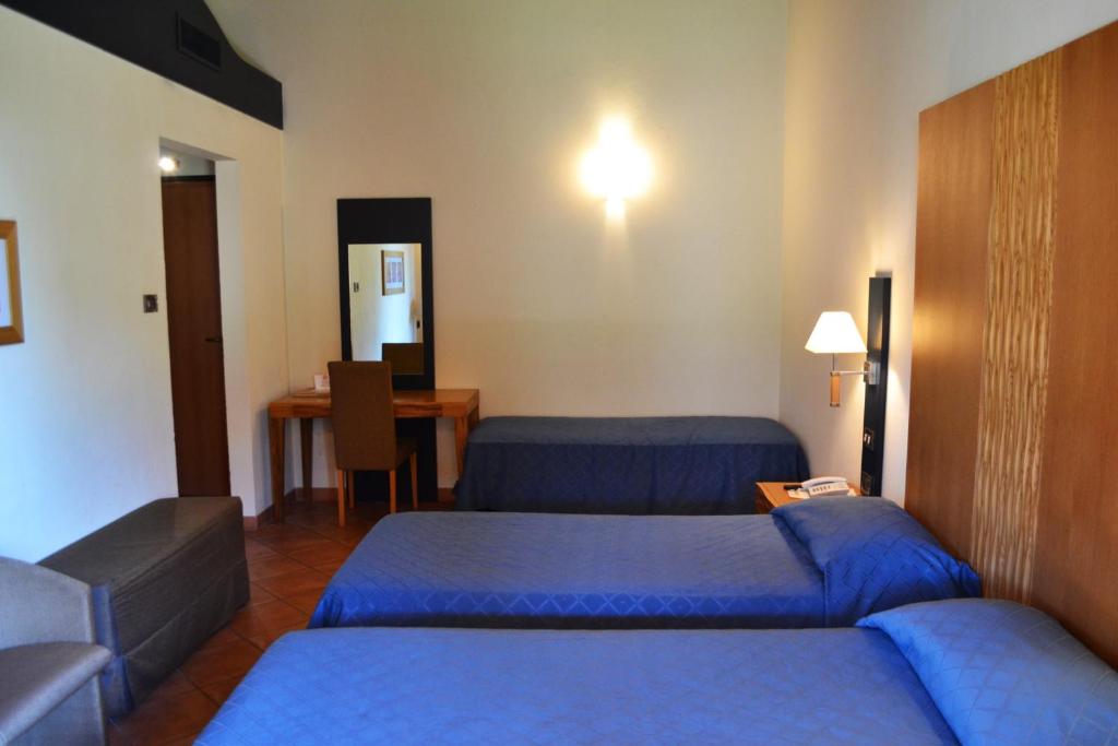 Postel nebo postele na pokoji v ubytování Ariotto Village
