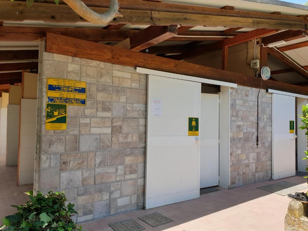 a group of three garage doors on a building at Campeggio Gianna Golfo dei Poeti in Lerici