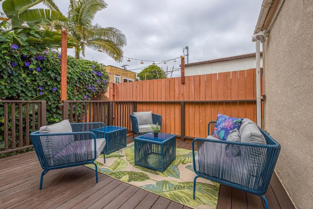 a patio with chairs and tables on a deck at Cottage By Mission Bay in San Diego