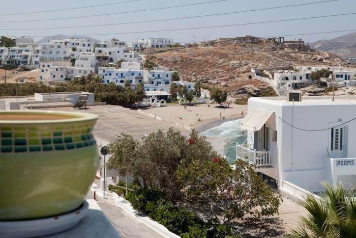 uma vista para a praia a partir de uma varanda com edifícios em Katerina Rooms em Naousa