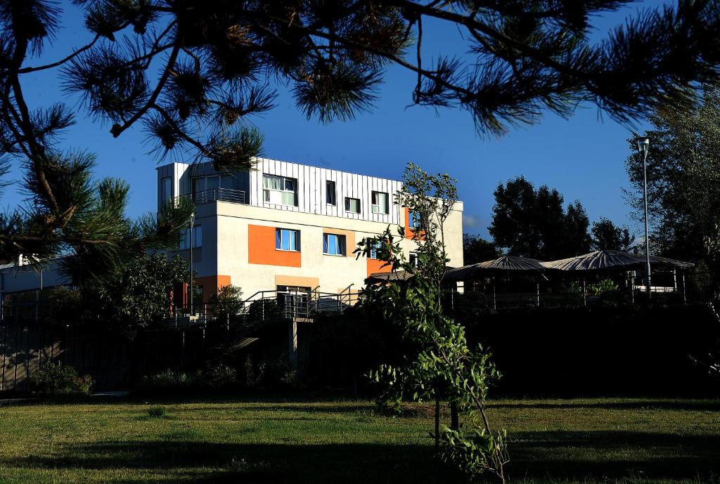 a building in the middle of a park at Hostel Dharma in Rijeka