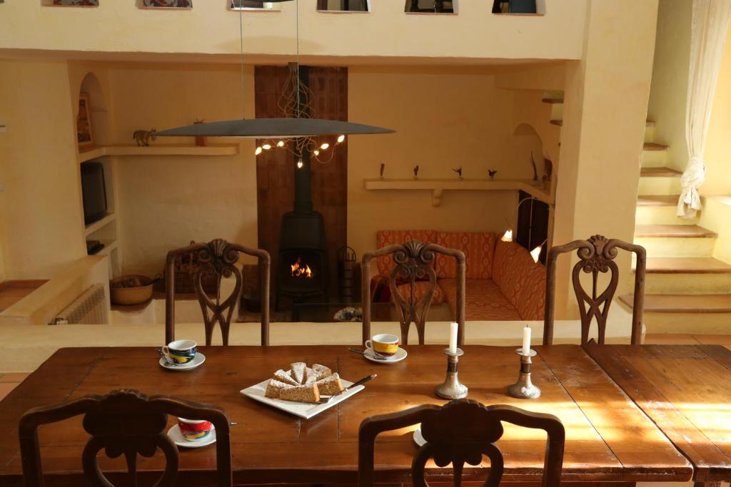a dining room table with two chairs and a fireplace at Finca Sa Tafona in Son Servera