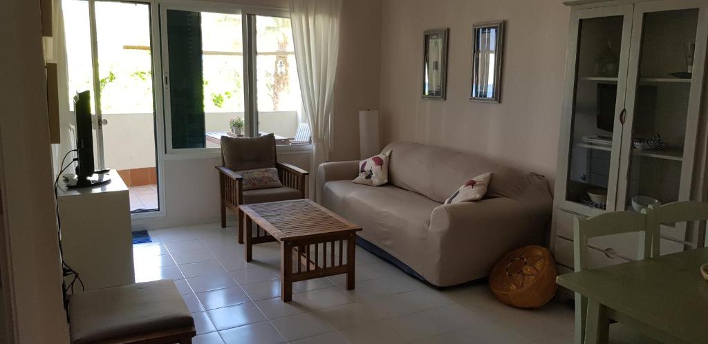 a living room with a couch and a chair at El Cantil in Isla Cristina