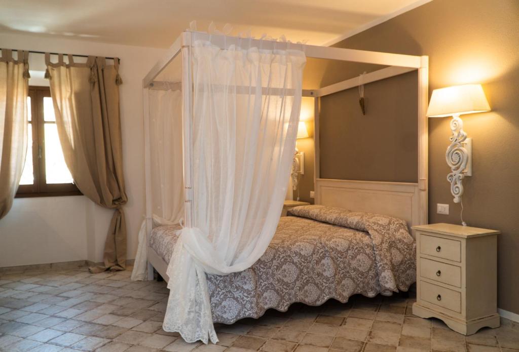 a bedroom with a bed with a canopy at Casa Lu Duttori in Arzachena