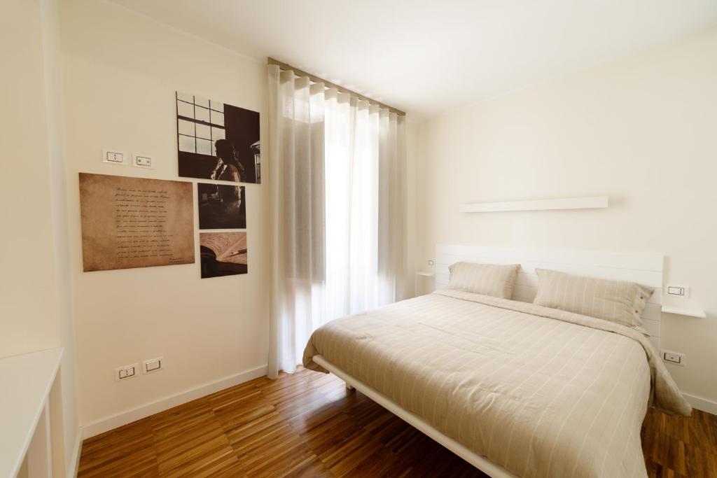 Un pat sau paturi într-o cameră la I VICOLI Exclusive Apartments