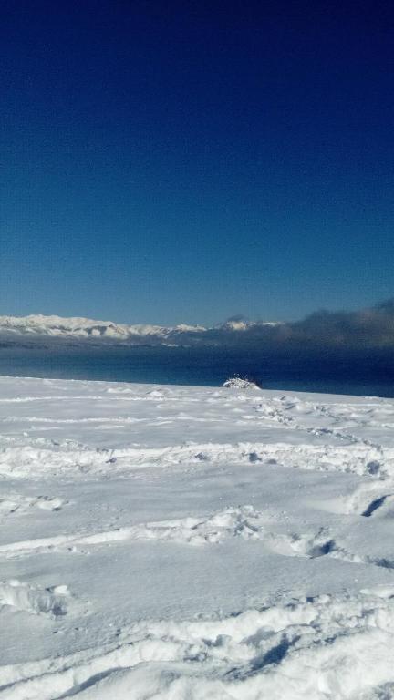 an aerial view of snow and clouds in the sky at Montalto in Dina Huapi