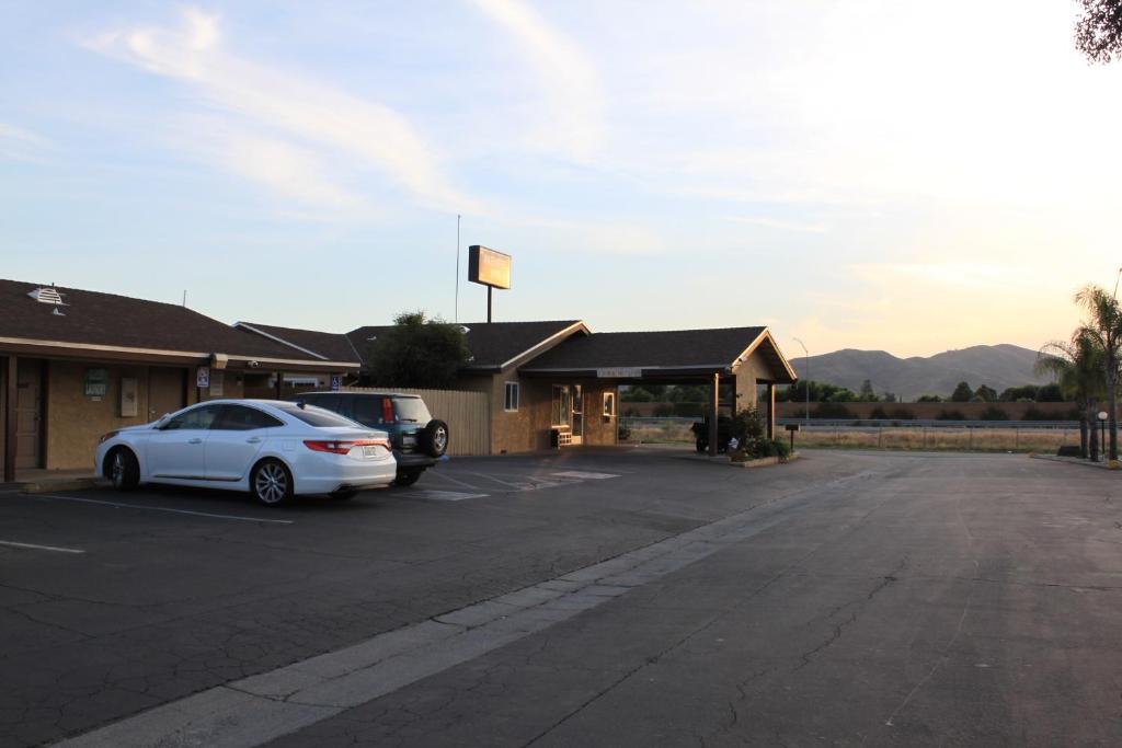 a car parked in a parking lot next to a building at Menifee Inn in Menifee