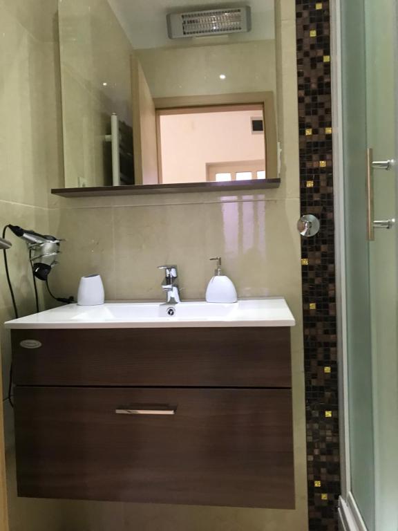 a bathroom with a sink and a mirror at Apartments Jani in Hvar