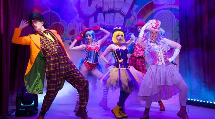 a group of people dressed in clown costumes on a stage at Private Caravan on Ty Mawr Holiday Park, North Wales in Conwy