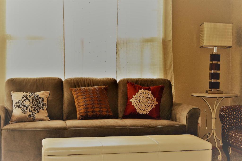 ein Sofa mit Kissen darauf im Wohnzimmer in der Unterkunft Prairie Comfort in Grand Forks
