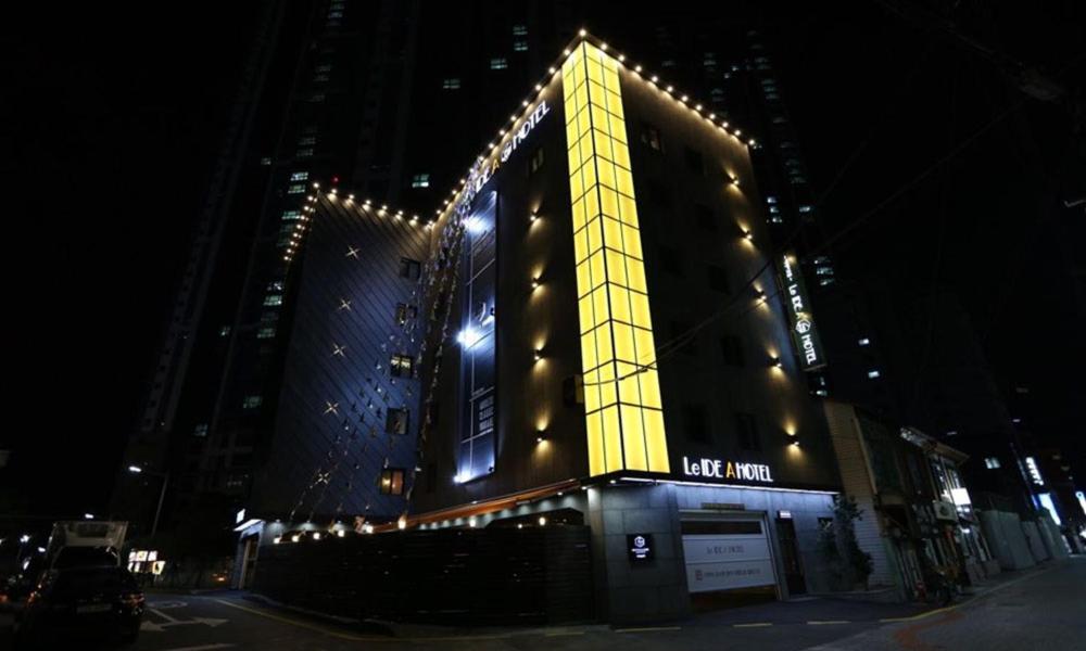 a lit up building with lights on it at night at Gupo Idea Hotel in Busan