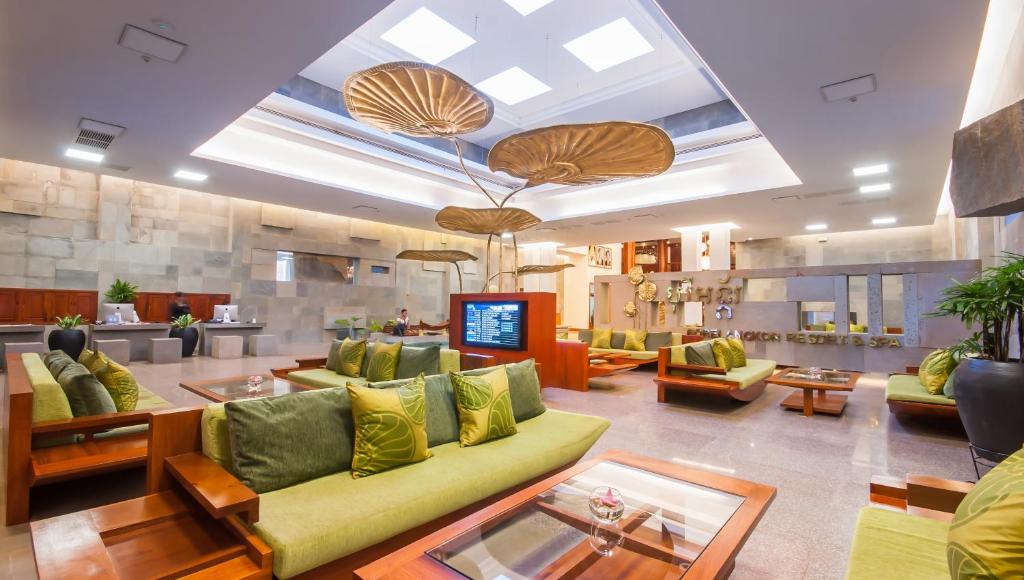 a large living room with a green couch and chairs at Borei Angkor Resort & Spa in Siem Reap