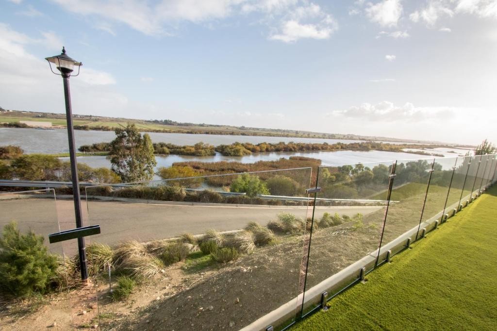 a street light next to a road next to a river at ‘Serenity’ and sweeping Murray River views in Tailem Bend