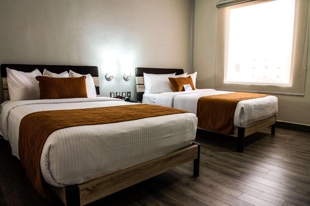 Postel nebo postele na pokoji v ubytování Comfort Inn Irapuato