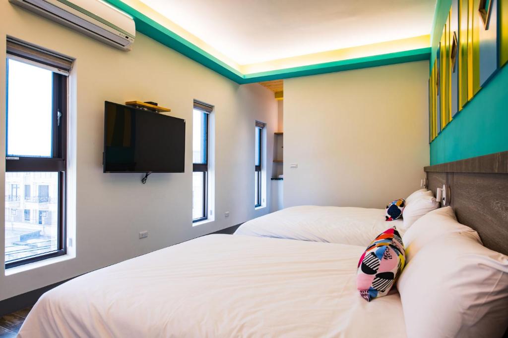 Postel nebo postele na pokoji v ubytování Happy Wing Guesthouse