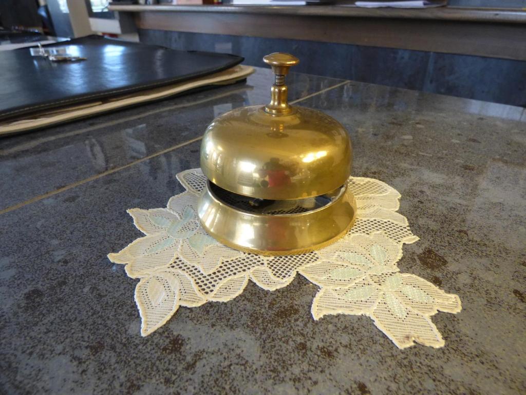 a gold bell sitting on top of a table at Hotel Turandot in Torre del Lago Puccini