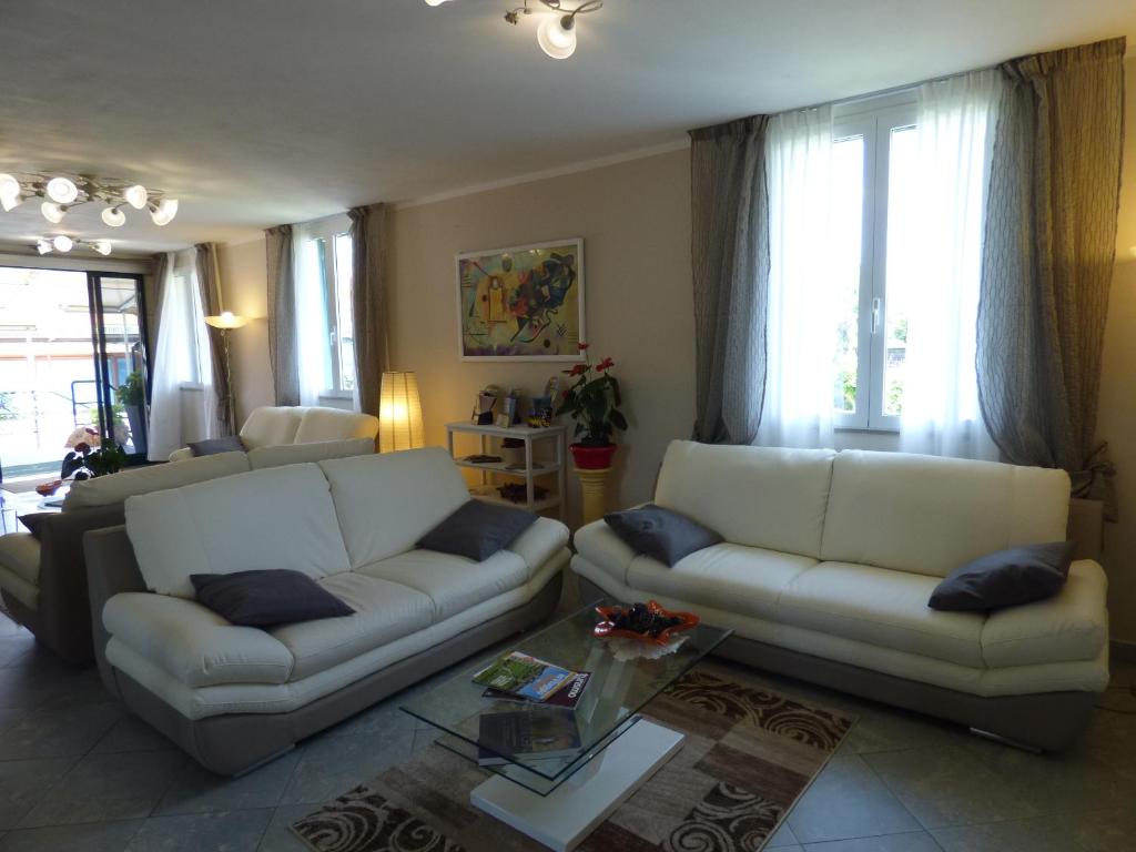 a living room with two couches and a table at Hotel Turandot in Torre del Lago Puccini