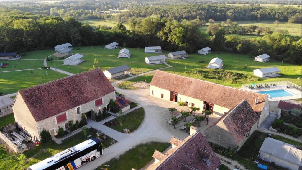 an aerial view of a farm with a building and tents at Camping Parc de la Brenne in Lignac