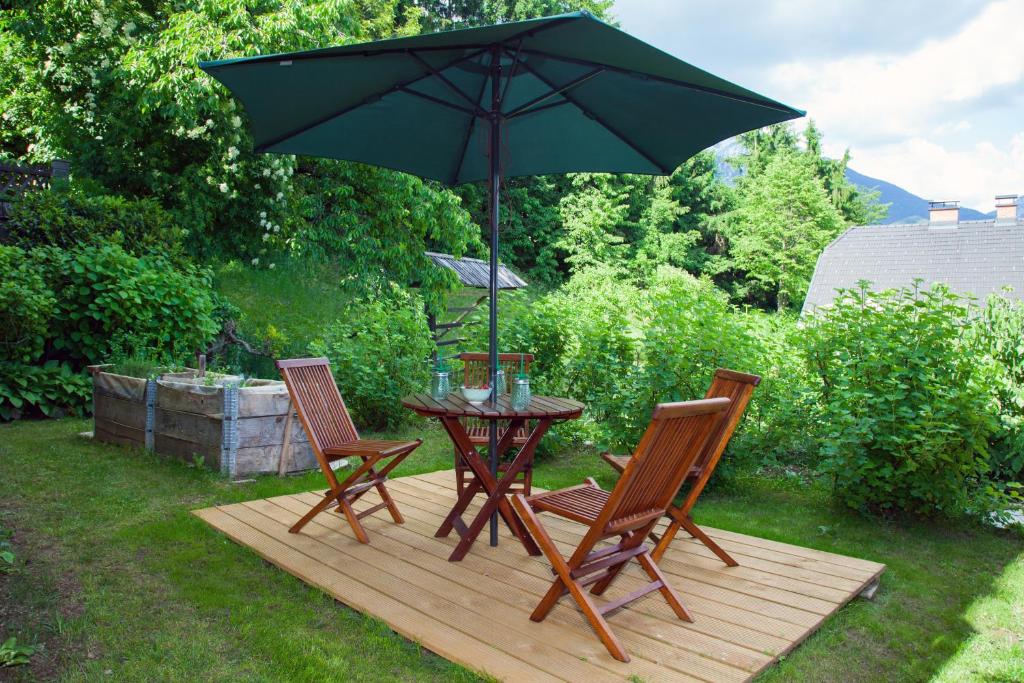 a table and chairs with an umbrella on a deck at STUDIO LUNA in Bled