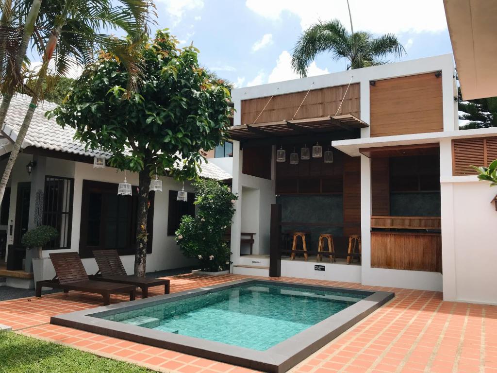 a swimming pool in front of a house at The Nest Samui in Bang Rak Beach