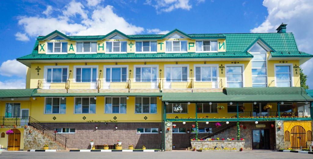 a large yellow building with a green roof at Hantri Hotel in Sergiyev Posad