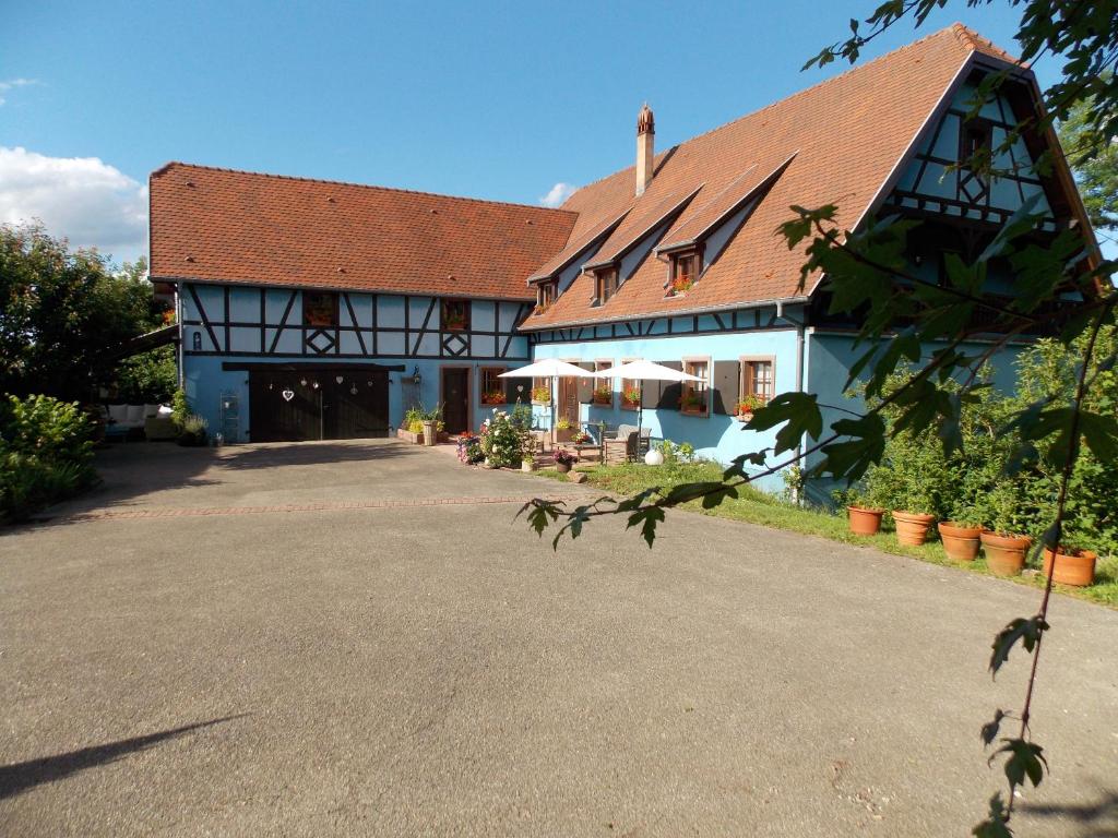 a large white building with a red roof at Le Gîte bleu in Willgottheim