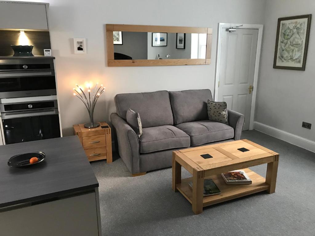 a living room with a couch and a table at The Luxury Apartment in Buxton