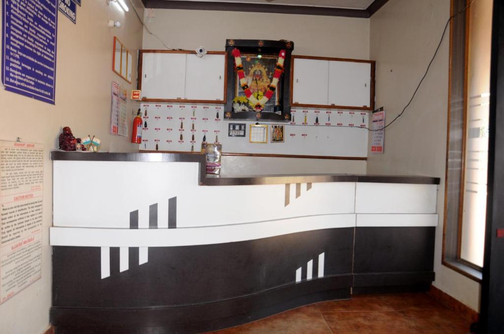 a room with a counter in a room at Shwetha Lodge in Kollūru