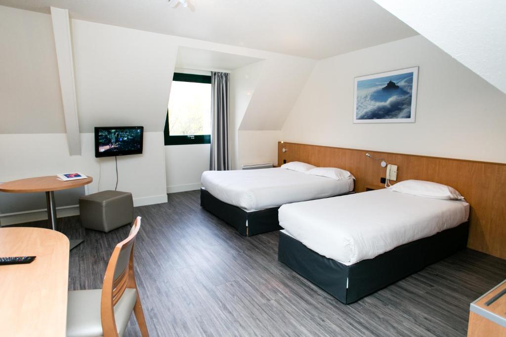 Postel nebo postele na pokoji v ubytování Hôtel Vert