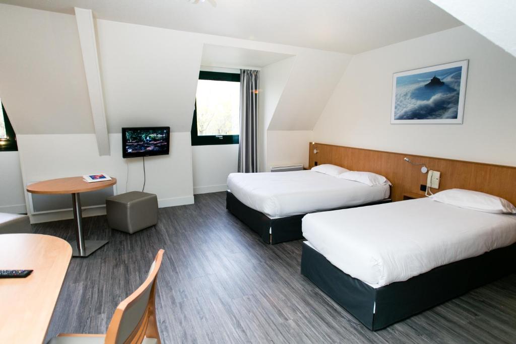 Postel nebo postele na pokoji v ubytování Hôtel Vert