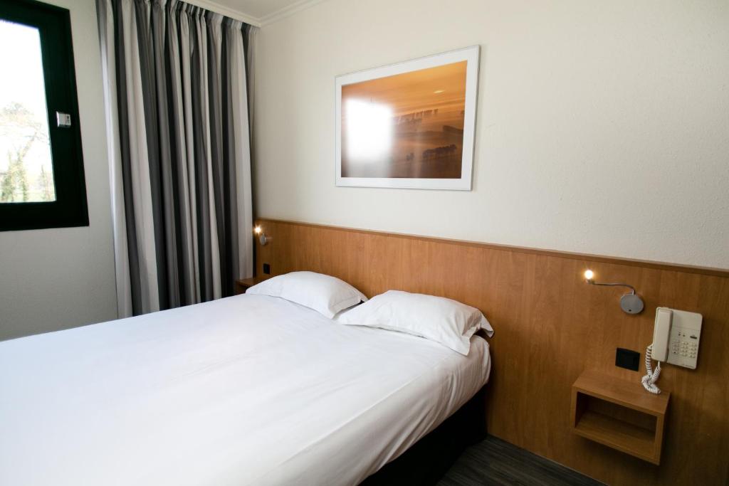 Postel nebo postele na pokoji v ubytování Hôtel Vert