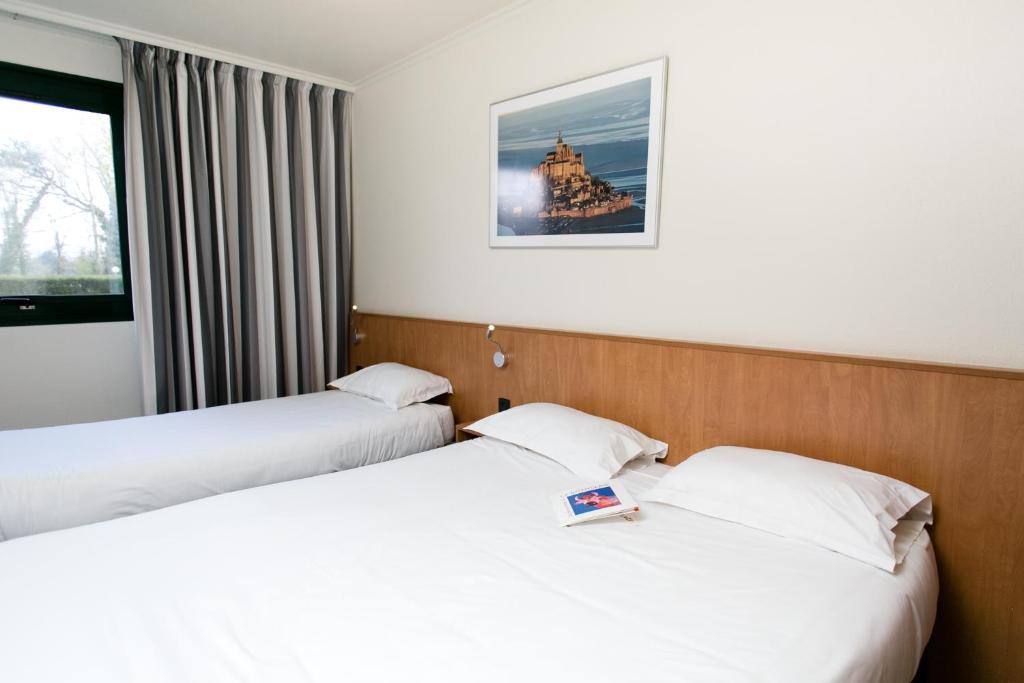 Postel nebo postele na pokoji v ubytování Hôtel Vert