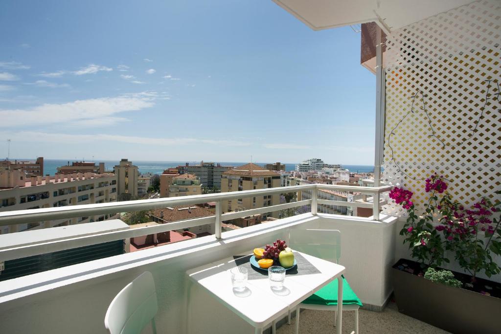 a balcony with a table with glasses of fruit on it at MONKÓ LOVELY, QUIET & CENTER SEA VIEWS o in Torremolinos