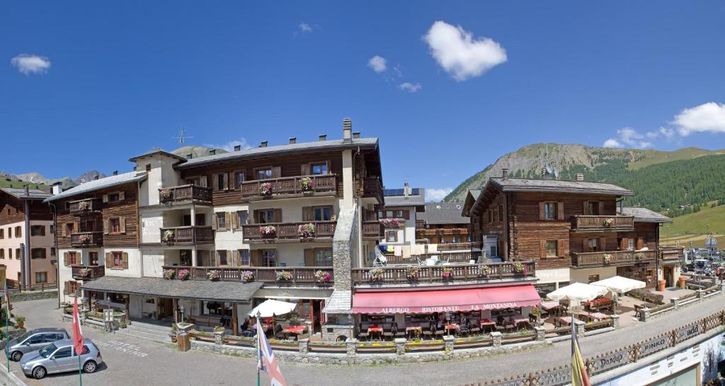 a large building with a restaurant in front of it at Hotel La Montanina in Livigno