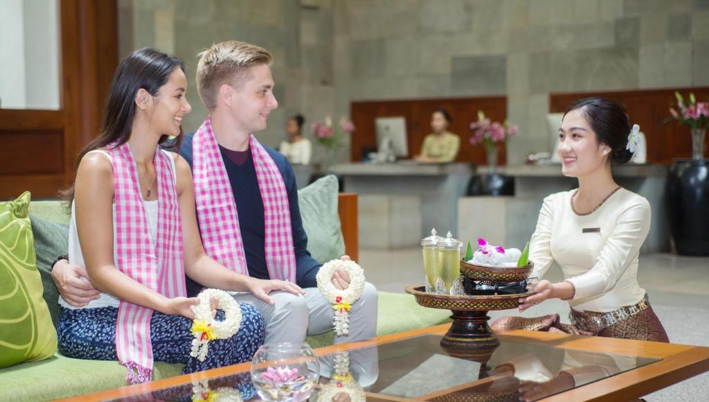a group of three people sitting around a coffee table at Borei Angkor Resort & Spa in Siem Reap