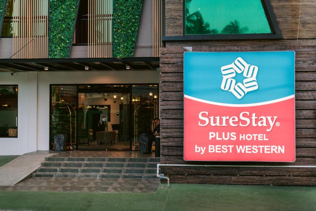 una señal en el lateral de un edificio en SureStay Plus Hotel by Best Western AC LUXE Angeles City, en Ángeles