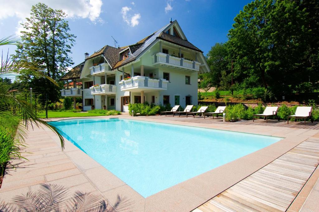 uma casa grande com uma piscina em frente em Villa Anina em Collalbo