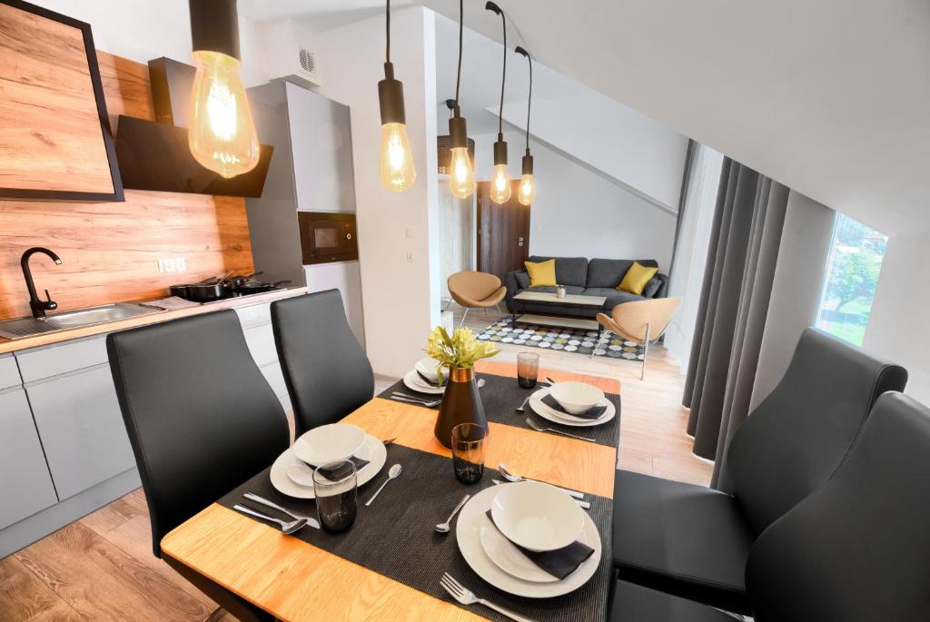 a kitchen and dining room with a table and chairs at Coffee Inn in Gdańsk