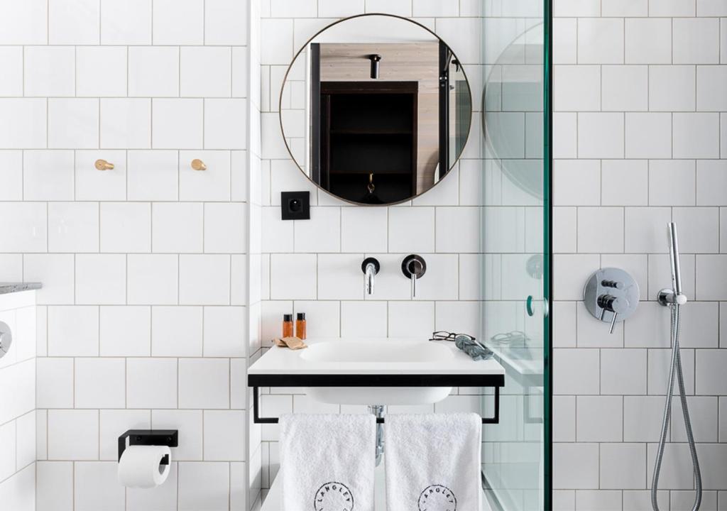 a bathroom with a sink and a mirror at Langley Hôtel Tignes 2100 in Tignes