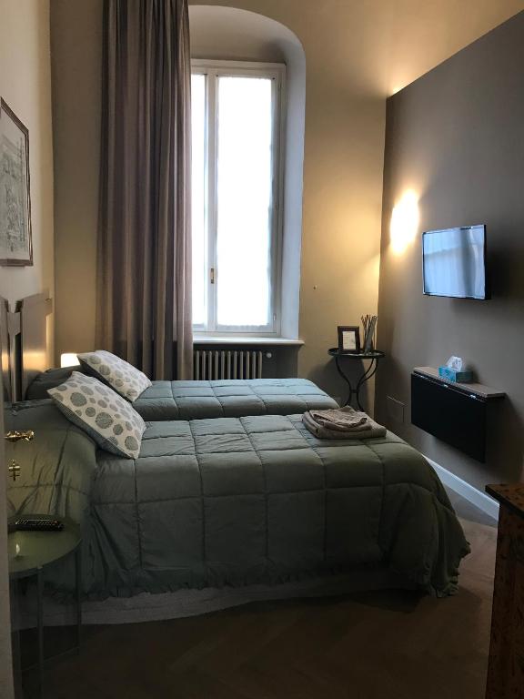 Postel nebo postele na pokoji v ubytování Luigi in Palazzo Bianchi