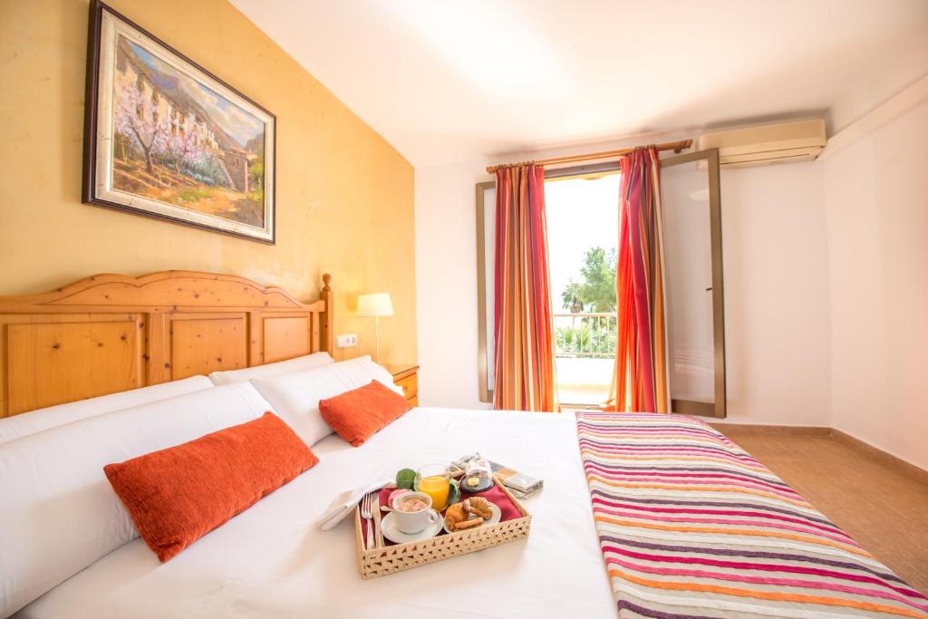 Кровать или кровати в номере Aparthotel Ona Aucanada