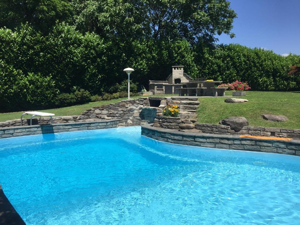 a swimming pool in a yard with a landscaping at Villa Alice in Lesa