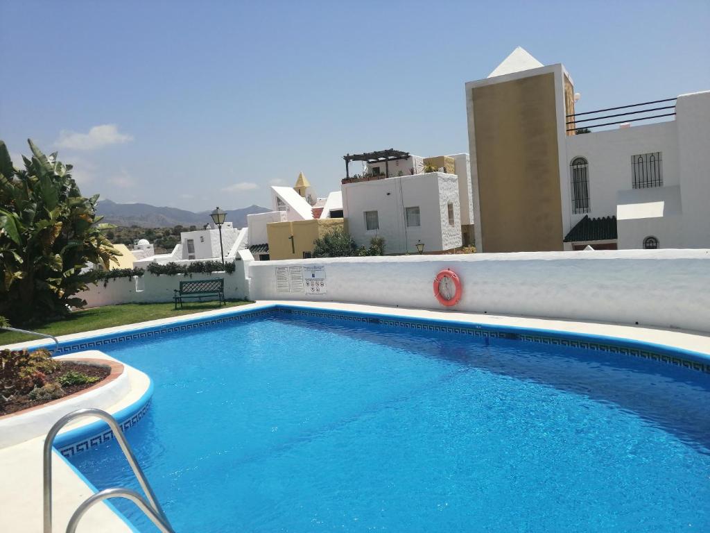 a large blue swimming pool on top of a building at Casablanca Villas in Nerja