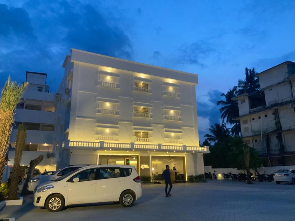 a white car parked in front of a building at HOTEL PARK RESIDENCY in Trichūr