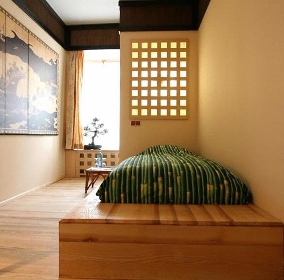 a bedroom with a bed in a room with a window at HIP Hotel in Heidelberg