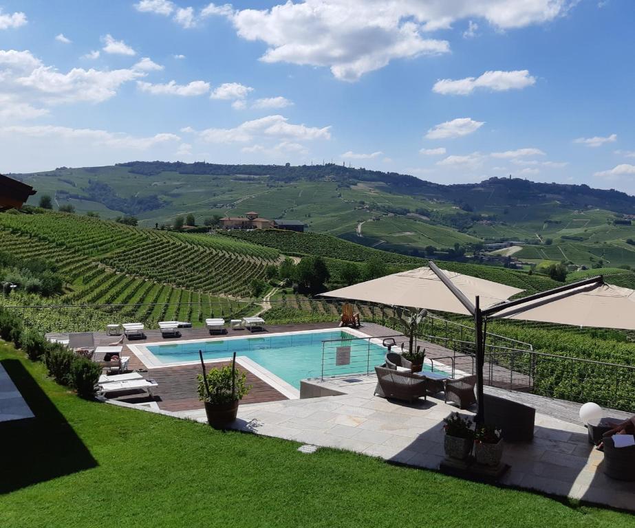 a swimming pool with a view of a vineyard at Casa Sobrero in Castiglione Falletto