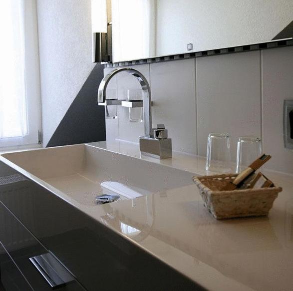 a bathroom counter with a sink with a knife at HIP Hotel in Heidelberg